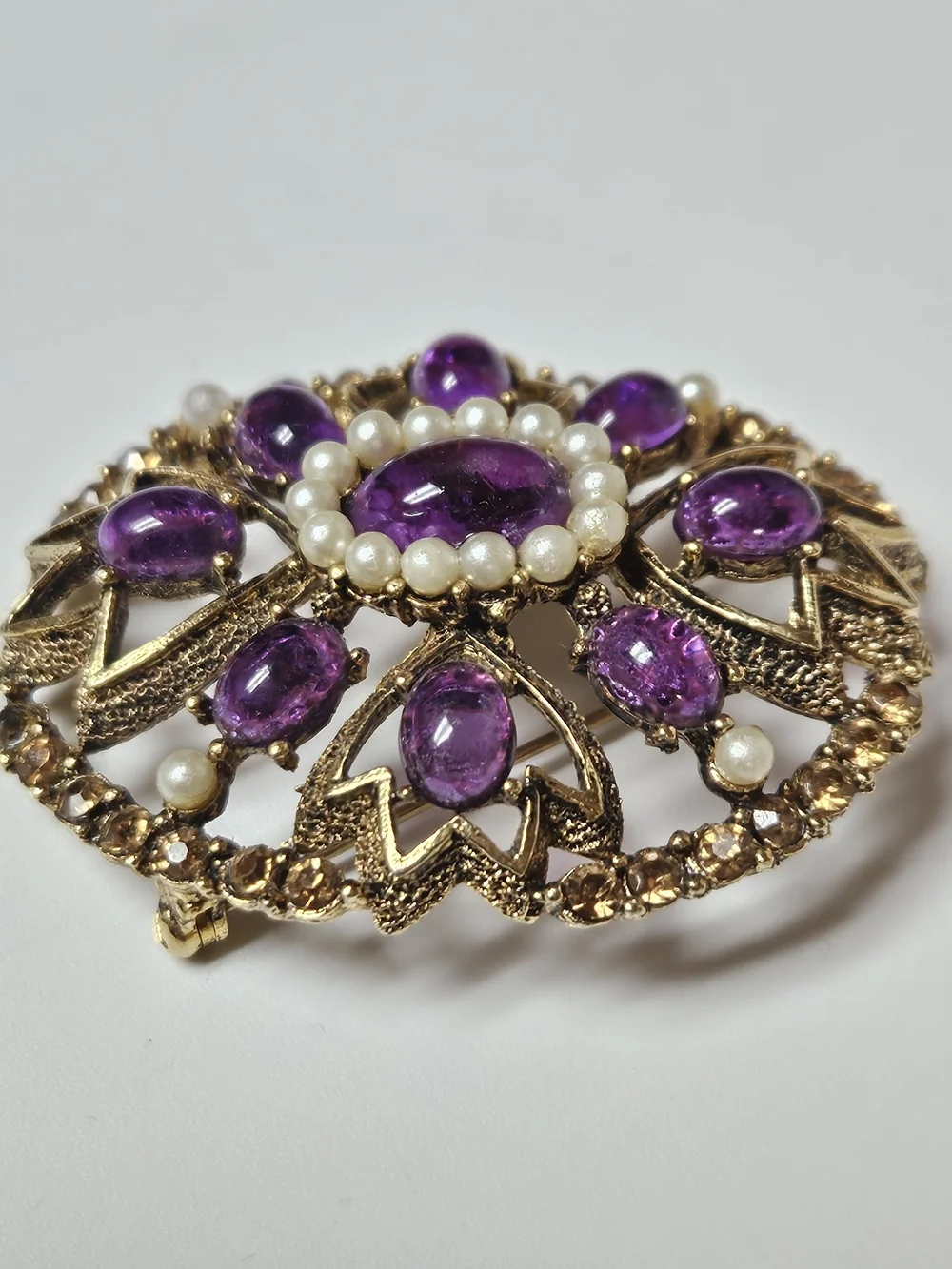 Gold-Tone Brooch with Purple Cabochons and Pearl Halo
